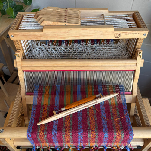 Handcrafted Maple Surf Shuttle made from durable hard maple, designed for fast, smooth weaving on rigid heddle, table, and small frame looms. Features a lightweight body, open slot design, and removable bobbin for easy yarn loading and efficient weaving.