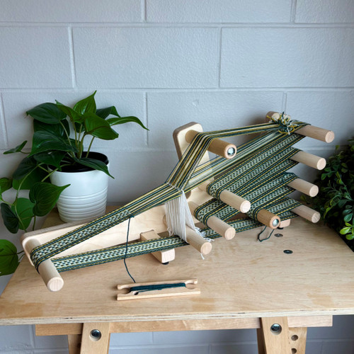 Handcrafted wooden inkle loom for band weaving and tablet weaving projects, featuring a smooth maple finish, adjustable tension, and portable design for fiber artists and weavers.