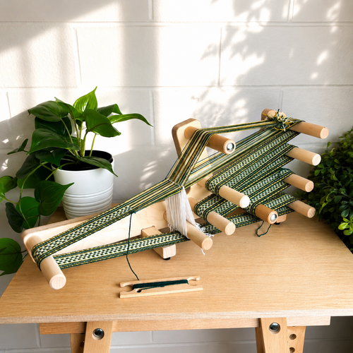 Handcrafted wooden inkle loom for band weaving and tablet weaving projects, featuring a smooth maple finish, adjustable tension, and portable design for fiber artists and weavers.