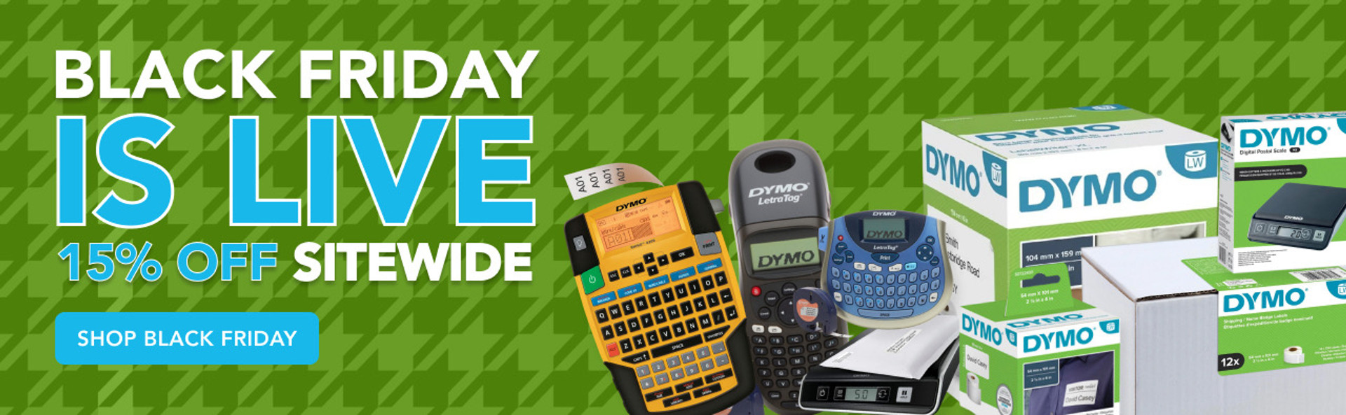 DymoOnline Black Friday banner showing ‘Black Friday Is Live – 15% Off Sitewide’ with a selection of DYMO label printers, labellers, postal scales and label rolls on a green houndstooth background.