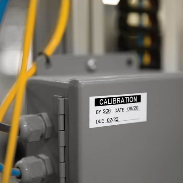 Calibration label applied to industrial electrical equipment with service date and due date fields