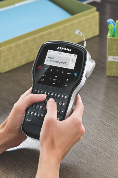 Hands using the DYMO LabelManager 280 handheld label maker at a desk for home or office organisation