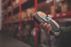 Person holding a DYMO LabelManager 420P in a warehouse aisle for portable shelf and stock labelling