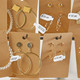 Jewellery display cards with DYMO price and barcode labels attached to earrings and accessories