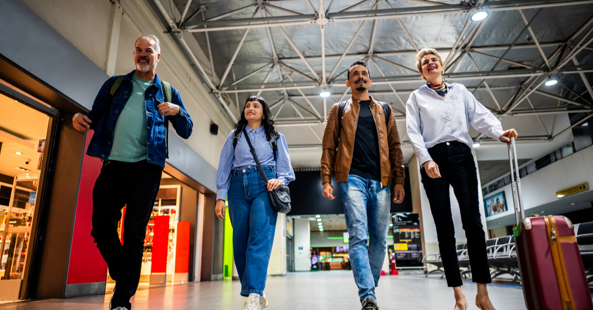 Travelers walking through a busy airport terminal with steady foot traffic for vending machine placement