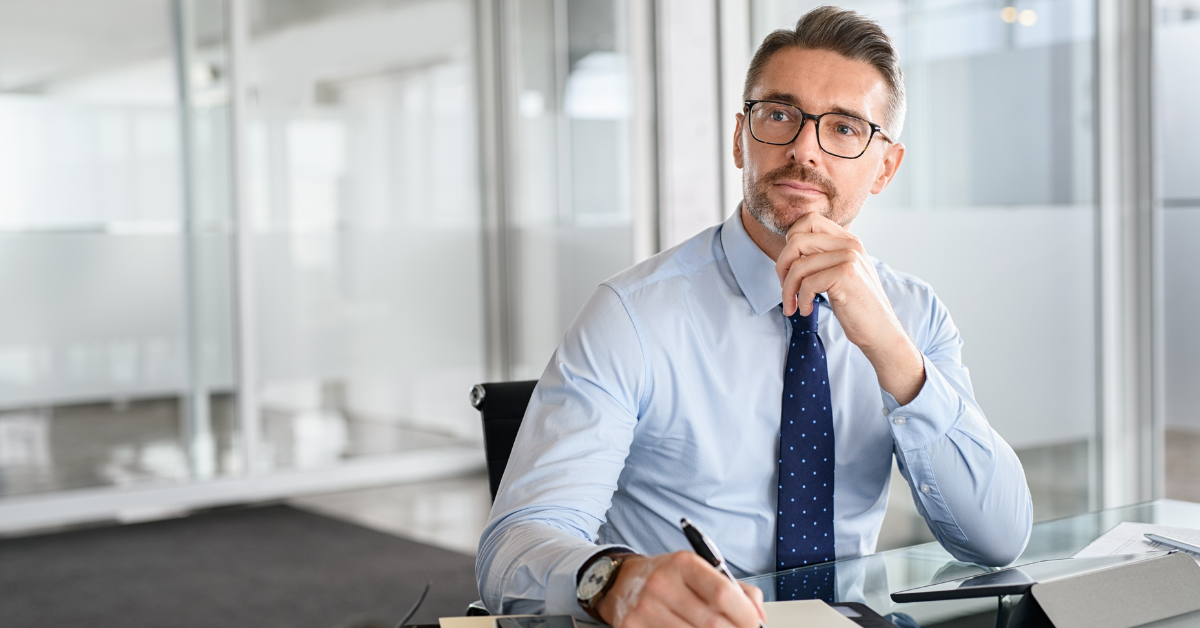 Business owner thoughtfully evaluating options to demonstrate an entrepreneurial mindset and informed decision-making