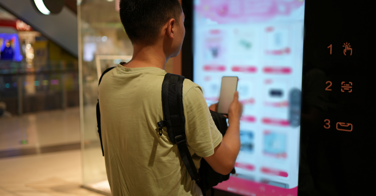 Customer using a modern vending machine, representing the next step in upgrading vending equipment for a better customer experience.