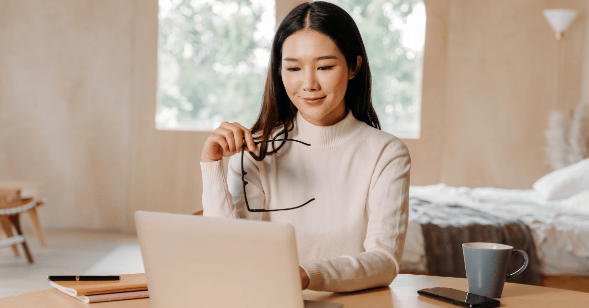 Professional woman working on a laptop in a home office, representing focused business planning, independent entrepreneurship, and flexible vending operations management