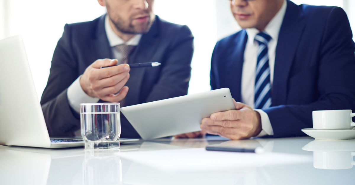 Business professionals reviewing vending machine location planning on a tablet