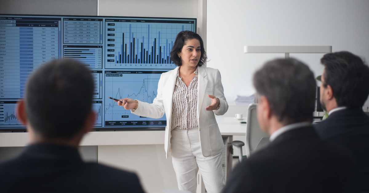 Business leader presenting growth strategies to a team, demonstrating resilient leadership and informed decision-making