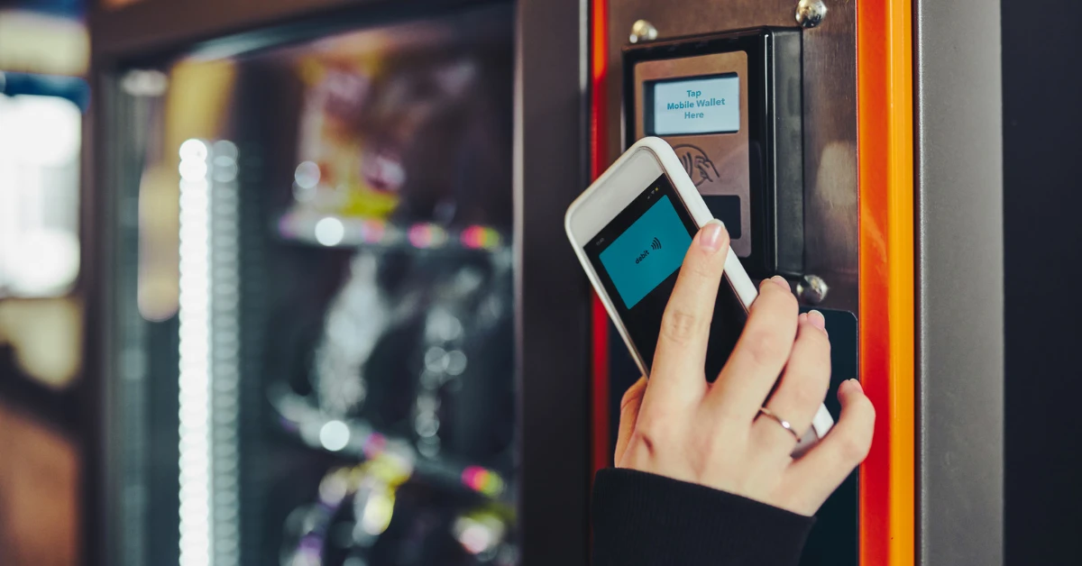Customer using a mobile wallet for contactless payment at a smart cooler