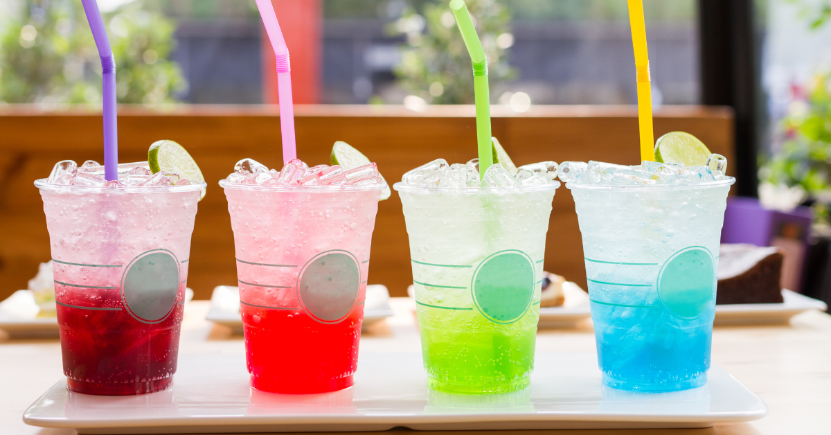 Colorful cold summer drinks with ice and straws representing water, soda, energy drinks, and sports drinks for vending machines