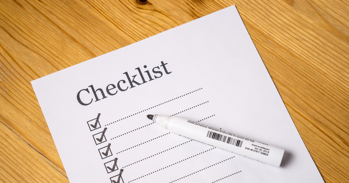 Person writing a vending machine location checklist in a notebook