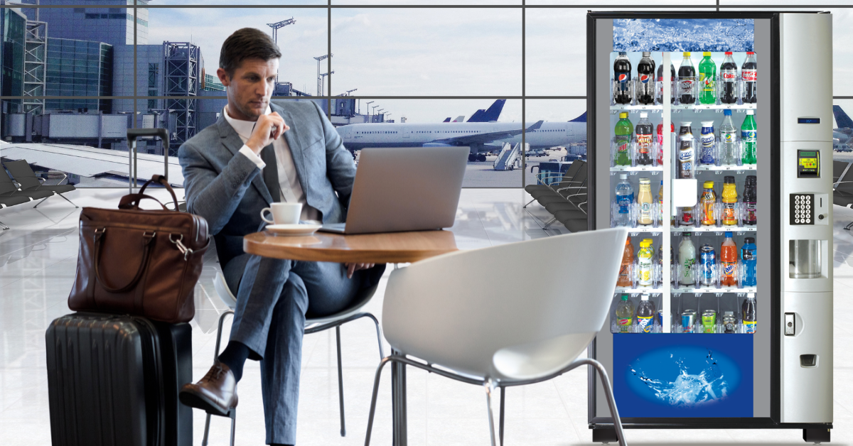 Business traveler using a laptop near a vending machine in an airport lounge