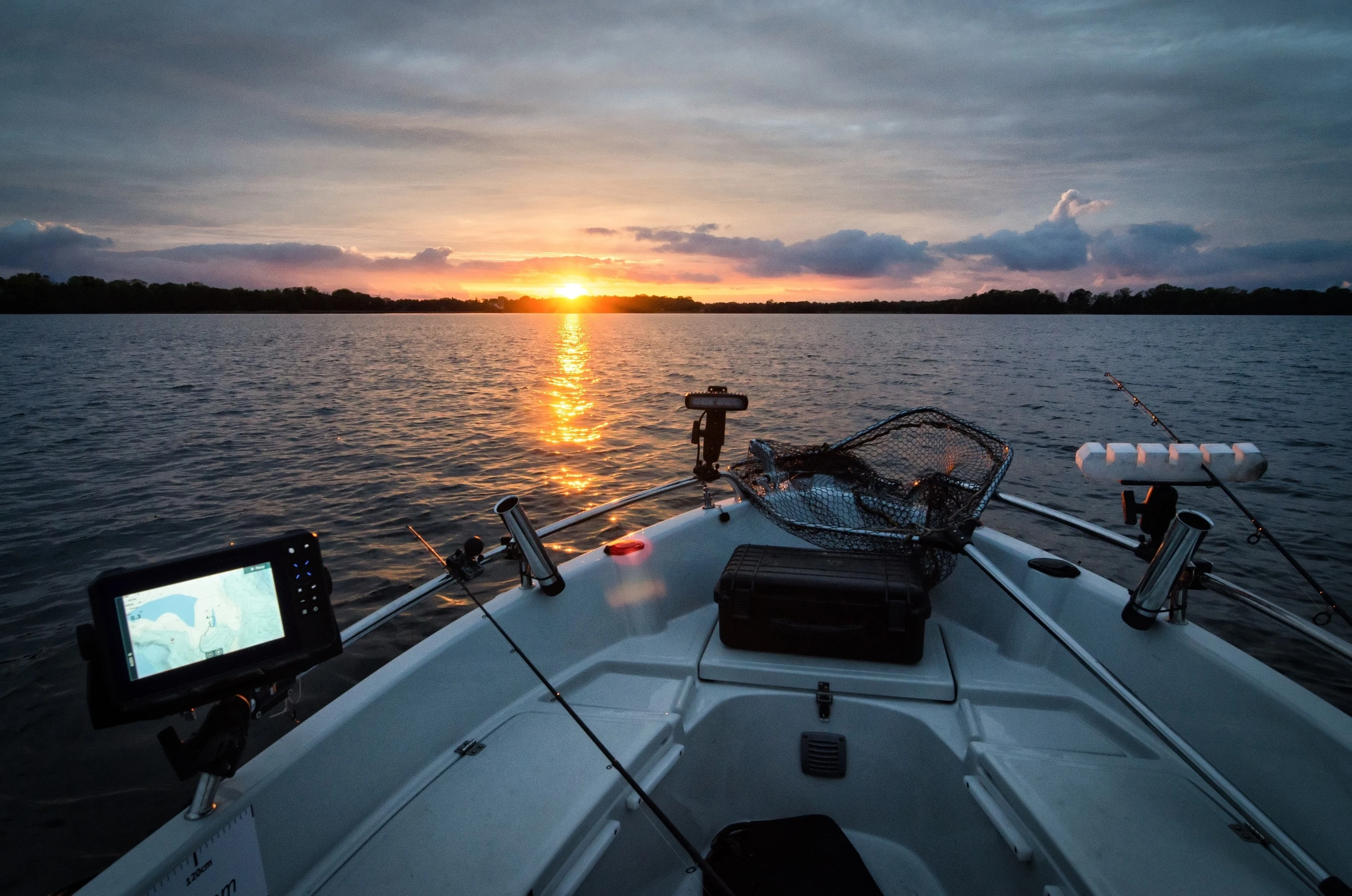 Silhouetted fishing boat at sunset