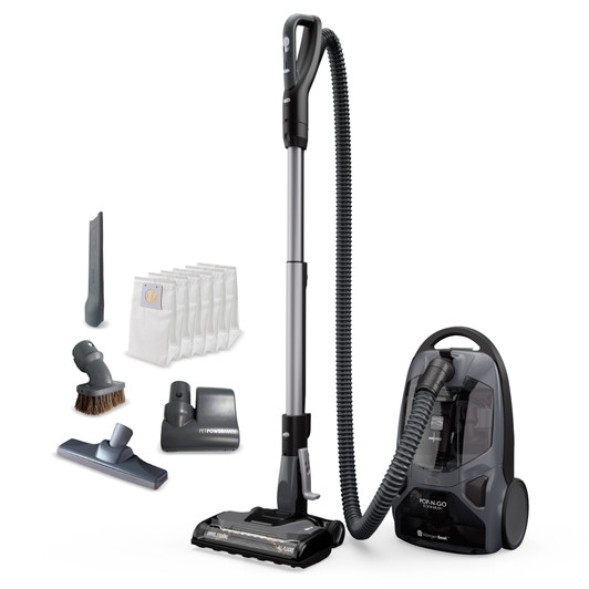 Canister vacuum sitting on it's end with wand standing to the