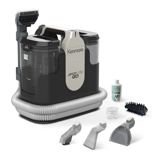 A spot cleaner and accessories are displayed on a white background