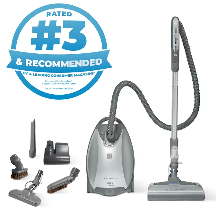 Canister vacuum and accessories on white background