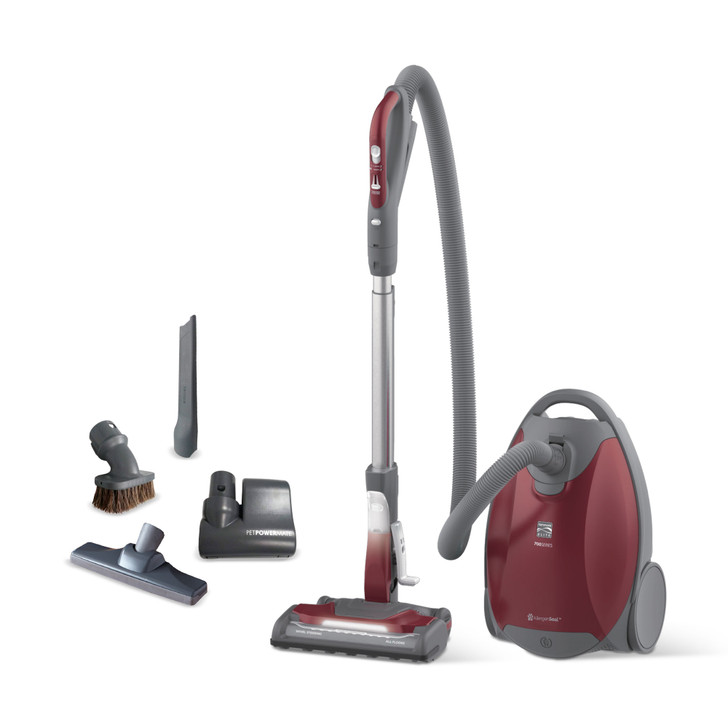 Red canister vacuum on white background. Included accessories are shown to the left - Bare floor tool, dust brush, crevice tool, Pet PowerMate.
