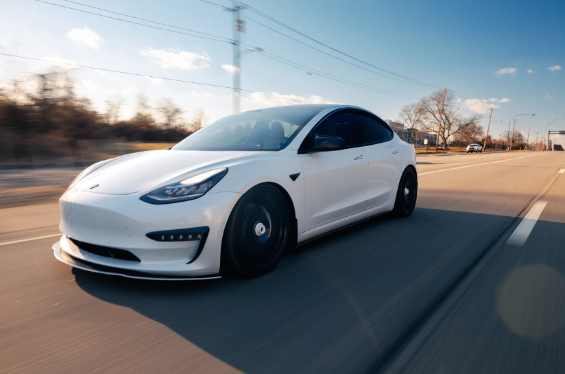 A Tesla driving at high speed who’s owner has been keeping up with  the Tesla maintenance costs