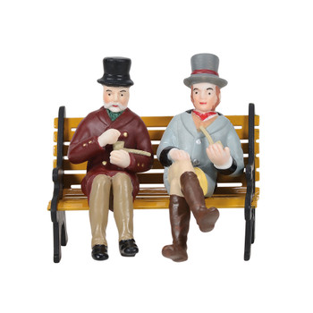 Set of 2, a couple of gents enjoy a pipe. Created to sit on bench or wall, bench not included. This Village accessory is hand-crafted, hand-painted, porcelain. Bench sold separately.