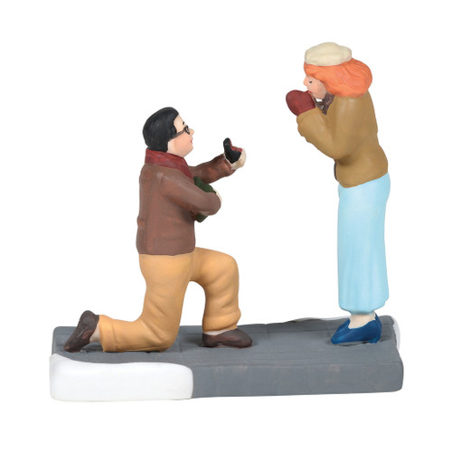 A partner on one knee with ring in hand is the dream of many girls hoping for a holiday engagement. this Village accessory is hand-crafted, hand-painted, Porcelain. A partner on one knee with ring in hand is the dream of many girls hoping for a holiday engagement. this Village accessory is hand-crafted, hand-painted, Porcelain.