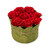 A handmade paper box with a flat lid adorned with red paper roses and green leaf details, containing 1.5 pounds of assorted premium chocolates, including ashta-flavored chocolates with pistachio toppings and chocolates in see-through wrapping.