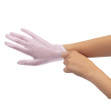 A pair of hands putting on a pair of Fromm Pro Lilac Vinyl Gloves.