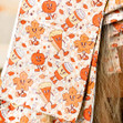 Sheets of orange Autumn themed haircoloring foil on a salon client.