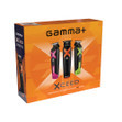 Orange packaging box containing the Gamma+ Xceed Trimmer, charge base, 4 wide blade guards, and other accessories.