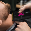 A barber using the Gamma+ Xceed Shaver on a client's neck.