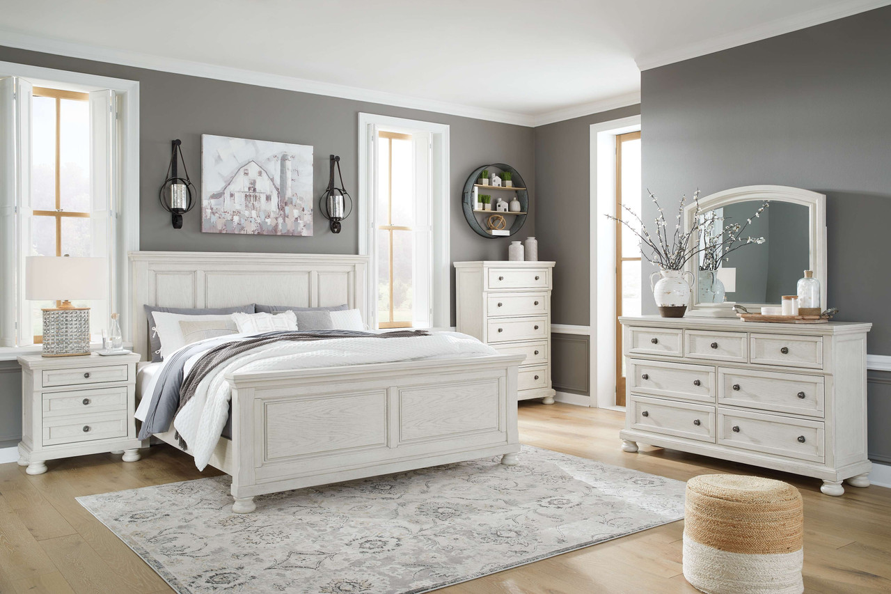 The Robbinsdale Antique White 8 Pc. Dresser, Mirror, Chest, King Panel Bed,  2 Nightstands is available at Discount Furniture Center proudly serving  South Hill and Farmville, VA and surrounding areas!