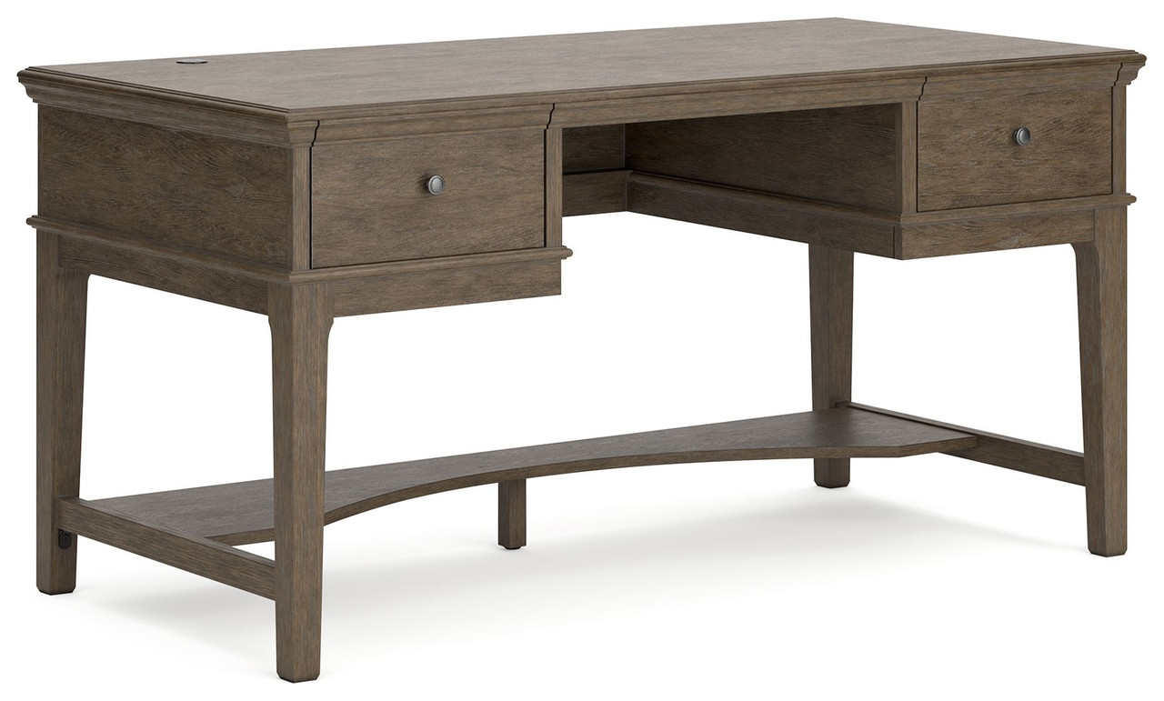 The Janismore Weathered Gray Home Office Storage Leg Desk is available at  Discount Furniture Center proudly serving South Hill and Farmville, VA and  surrounding areas!