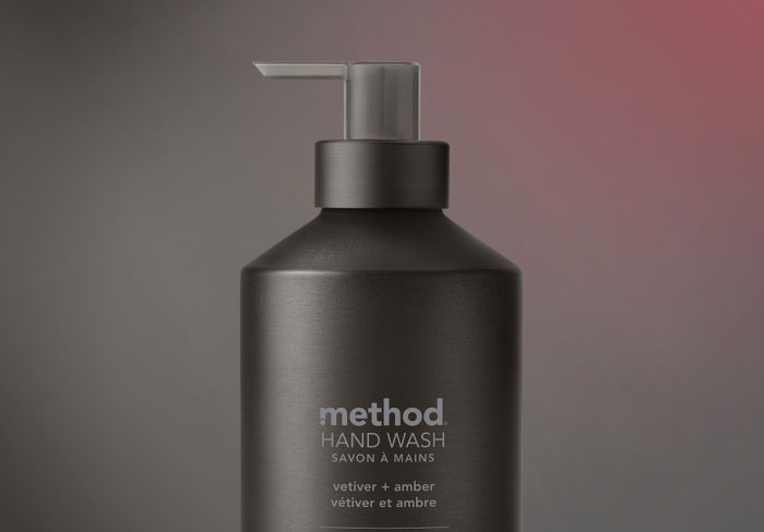 vetiver + amber hand wash on dark gradient background