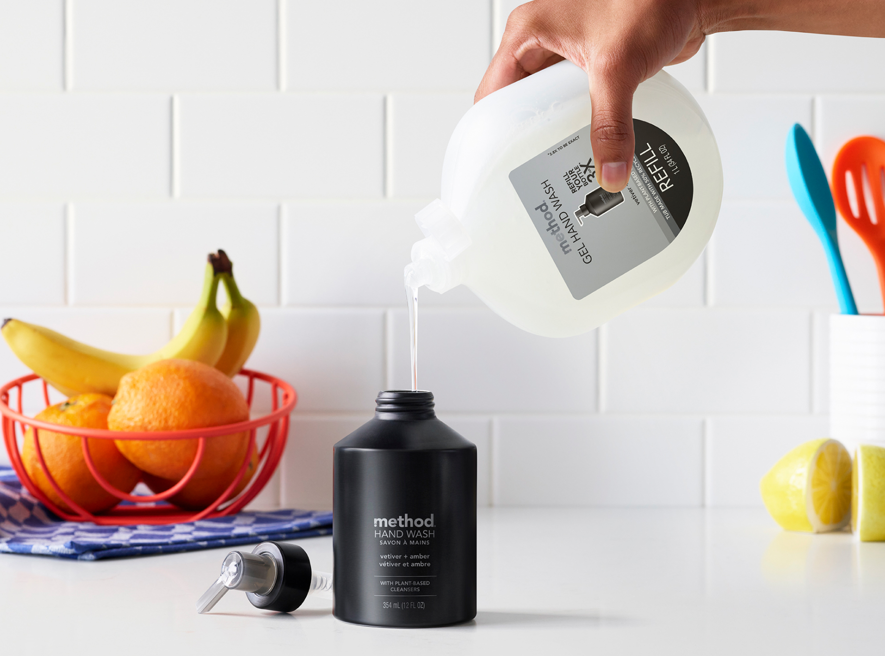 vetiver + amber refill being used to refill the aluminum bottle desktop version