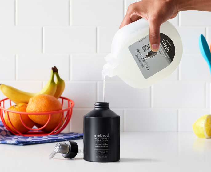 vetiver + amber refill being used to refill the aluminum bottle mobile version