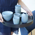 Cane-line Club aluminium round tray in black being carried.