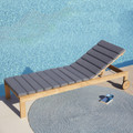 Cane-line Amaze cushion In Grey on a sunbed by a pool.