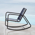 Cane-line Copenhagen rocking chair in lava grey, aluminium outdoors by the sea.