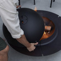 Cane-line Ember fire pit lid being placed on Large fire pit.