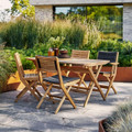 Cane-line Flip folding chairs surrounding table.