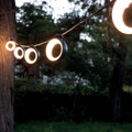 A set of Hoop lights in Acapulco Blue tied to a tree.