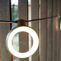 Close-up of the lit-up Cactus colour Hoop light by Fermob.