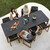 Cane-line Aspect dining table 210cm x 100cm Fossil Black ceramic top with three people seated.