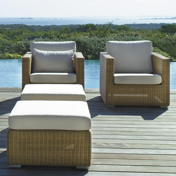Cane-line Chester lounge chairs in Natural and footstools with White cushions.