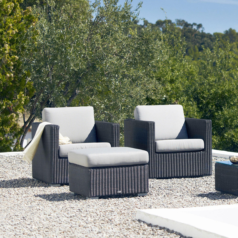 Cane-line Chester lounge chairs in Graphite and footstool with White cushions.