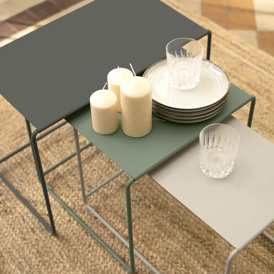 Oulala nesting tables with candle, plates & glasses.