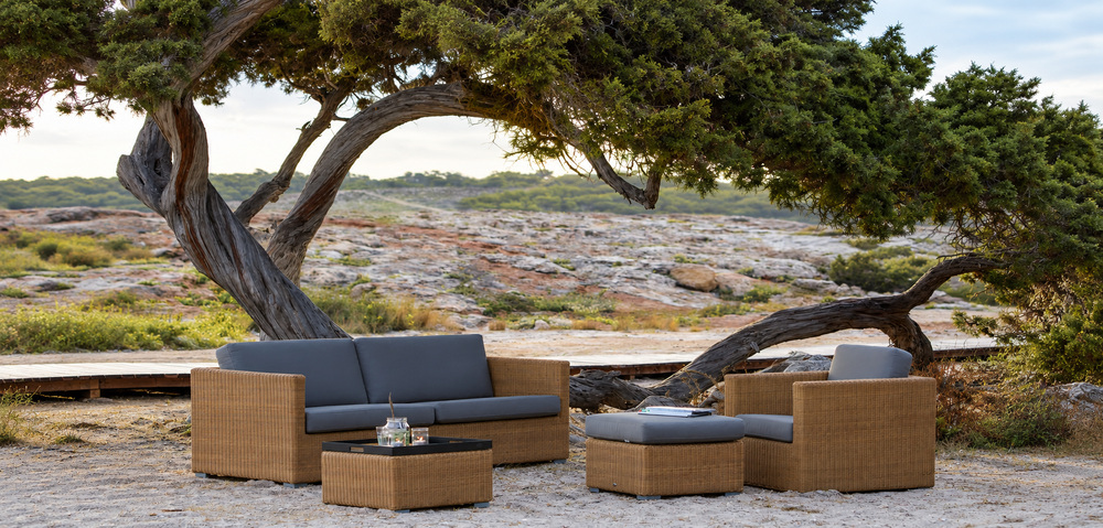 Woven outdoor lounge furniture in a coastal garden