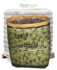 A large Roots Organics soil bag filled with potting mix, in front of a pallet of white bags.