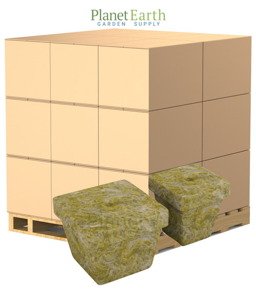 A large wooden pallet stacked with multiple tan cardboard cases, with two Grodan rockwool starter blocks in the foreground.